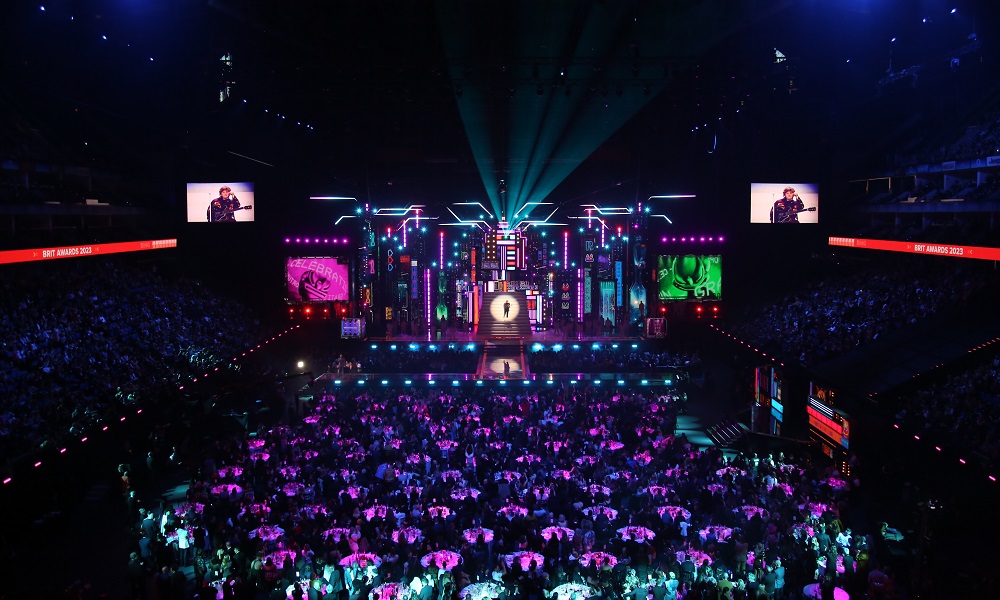 sit with arecord label table and guests at the brit awards 2026